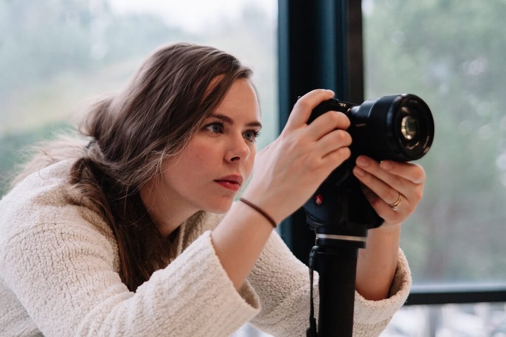 A woman taking pictures indoors