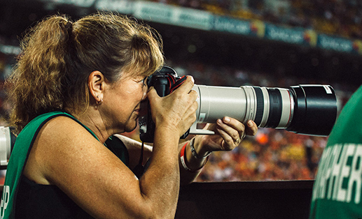 photographer using telephoto lens during a sports event