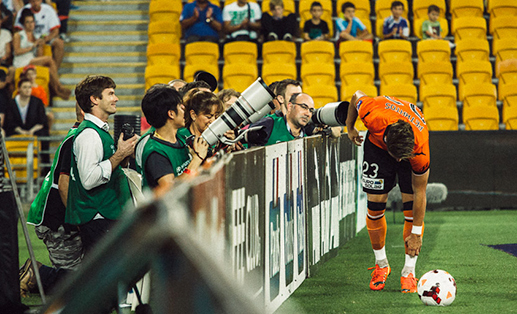 a group of photographers covering a soccer match