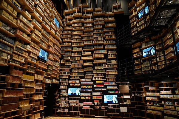 Three triple-storey walls of shelves packed with books, photographed with the Sony 24mm f2.8 G lens