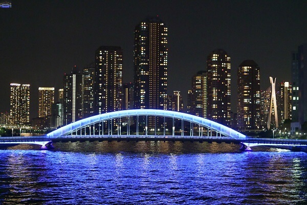 Bridge and water lit by blue light with skyscrapers in the background, shot with the Sony FX3 camera