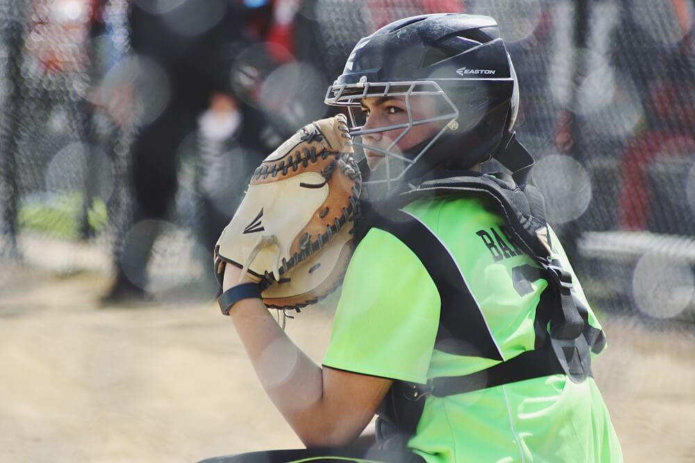 sports photography shot of a female baseball catcher