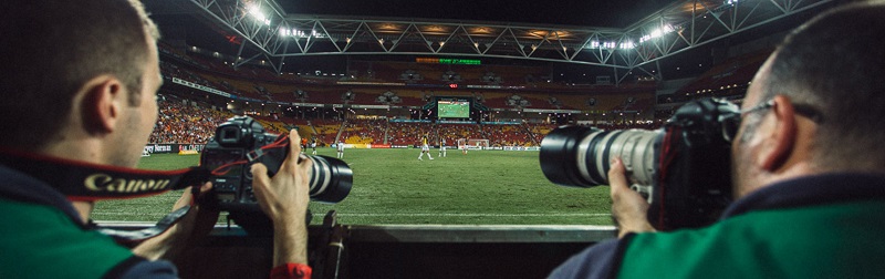 sports photographers covering a football match