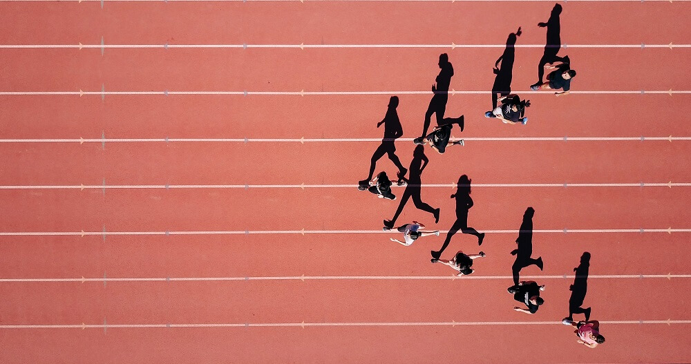 an aerial sports photography shot of a group of racers on the track