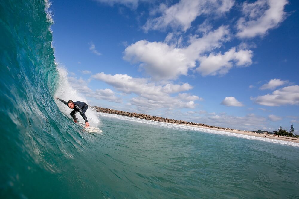 a sports photography shot of a surfer riding the waves