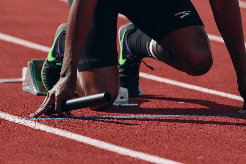 a sports photography shot of a runner's feet while on the starting lane