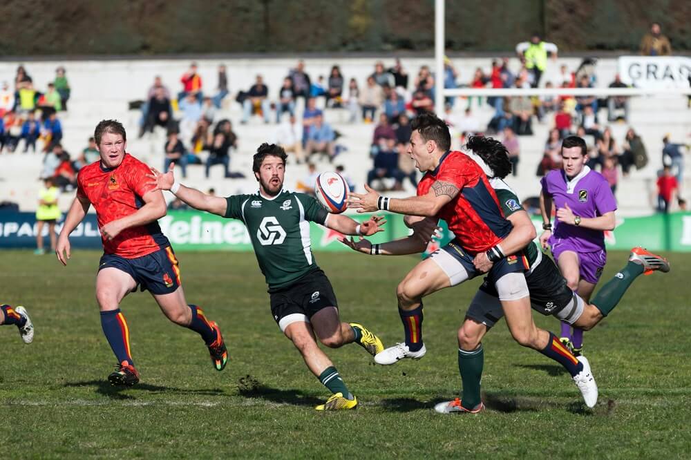 a sports photography shot of rugby players chasing the ball