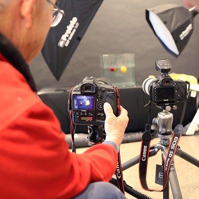 photographer shooting in a studio with a dslr and tripod