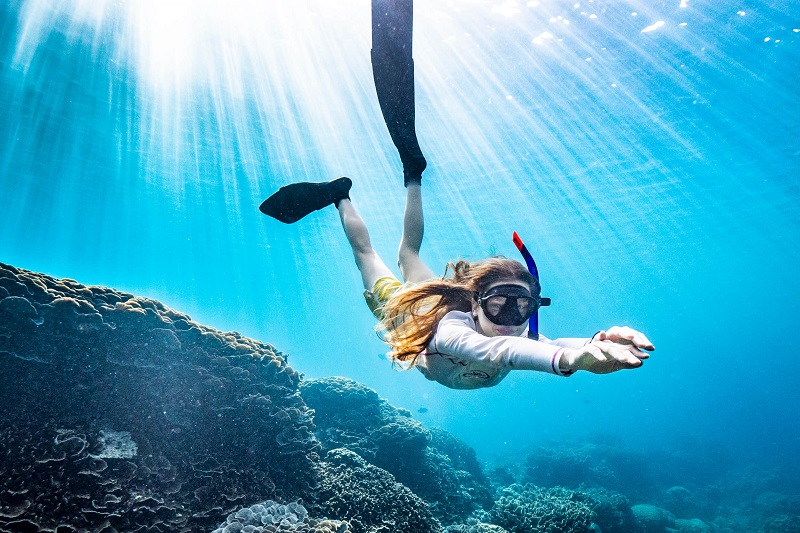 woman diving underwater in christmas island