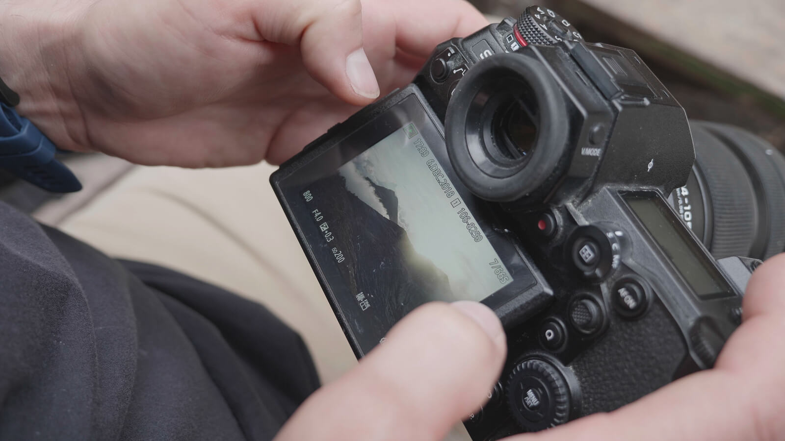 man checking the display screen of the new lumix camera