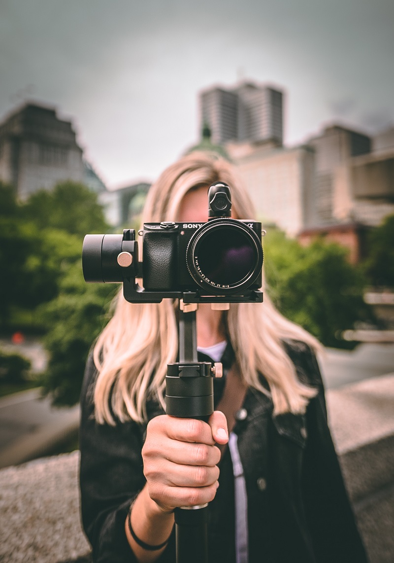 woman holding a camera with a gimbal