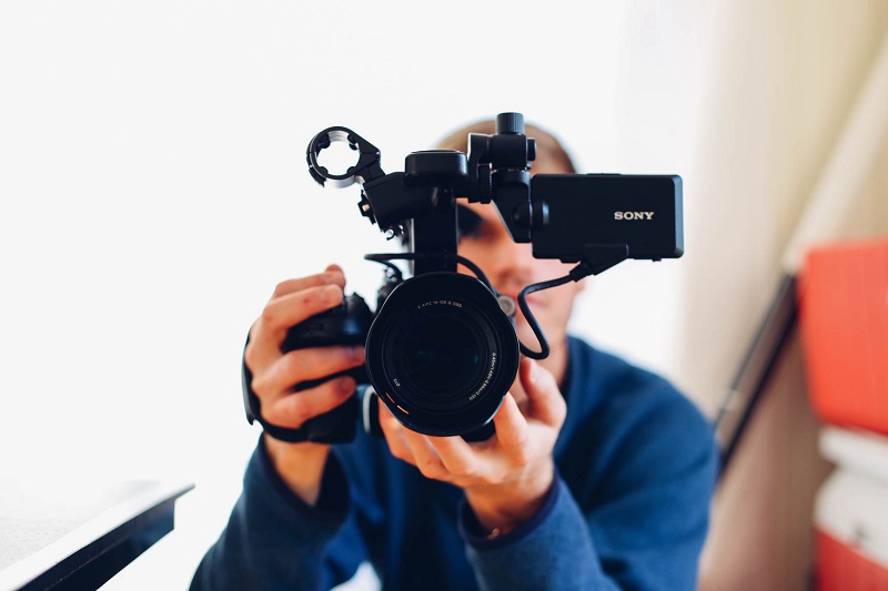 man holding a sony video camera