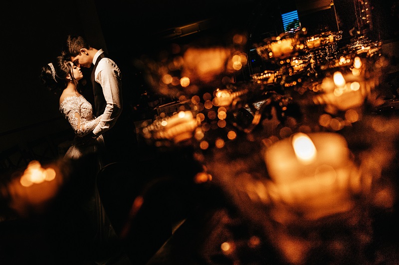 a romantic wedding shot of a the bride and groom in a low light setting