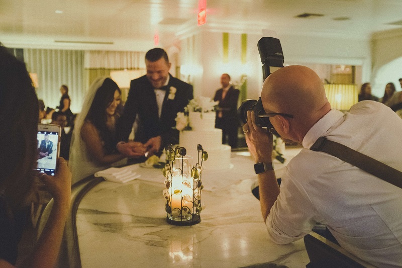 a wedding photo of the bride and groom slicing the cake