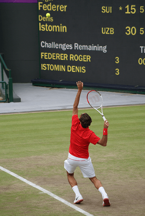 tennis player in red serving